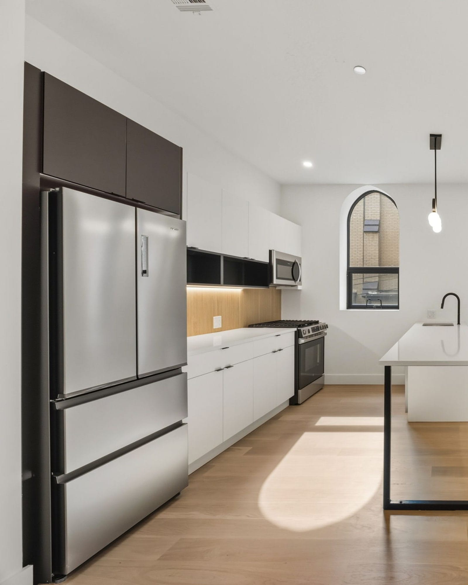 The Caliburn, Jersey City Heights — a residence under the building's original arched windows